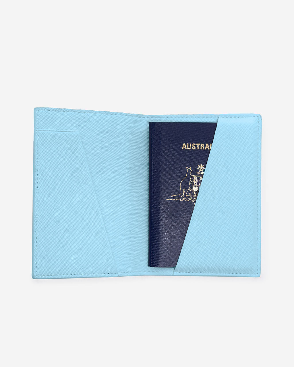 Open light blue Saffiano leather passport holder displaying an Australian passport partially inserted into the right-hand pocket.