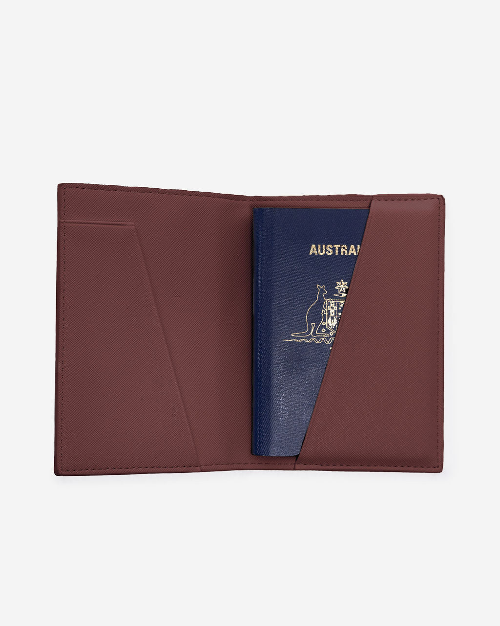 Open brown Saffiano leather passport holder displaying an Australian passport in the right-hand pocket.