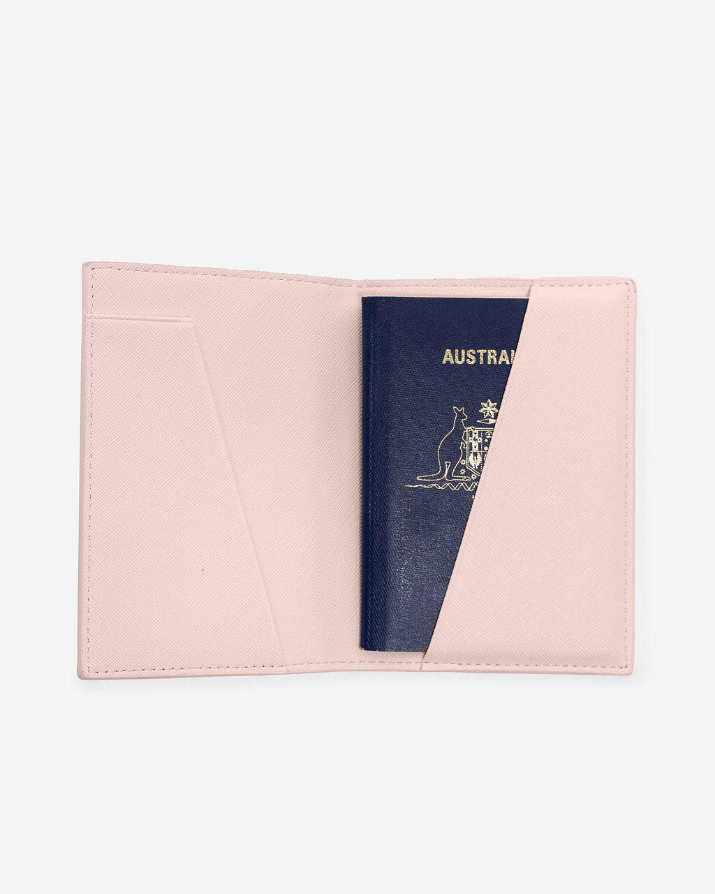 Open light pink Saffiano leather passport holder displaying an Australian passport partially inserted into the right-hand side pocket.