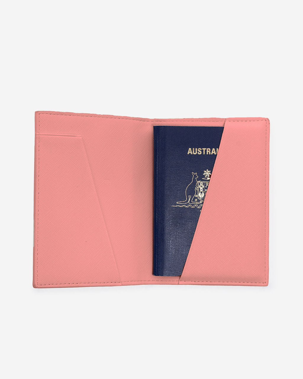 Open light pink Saffiano leather passport holder displaying an Australian passport partially inserted into the right-hand side pocket.