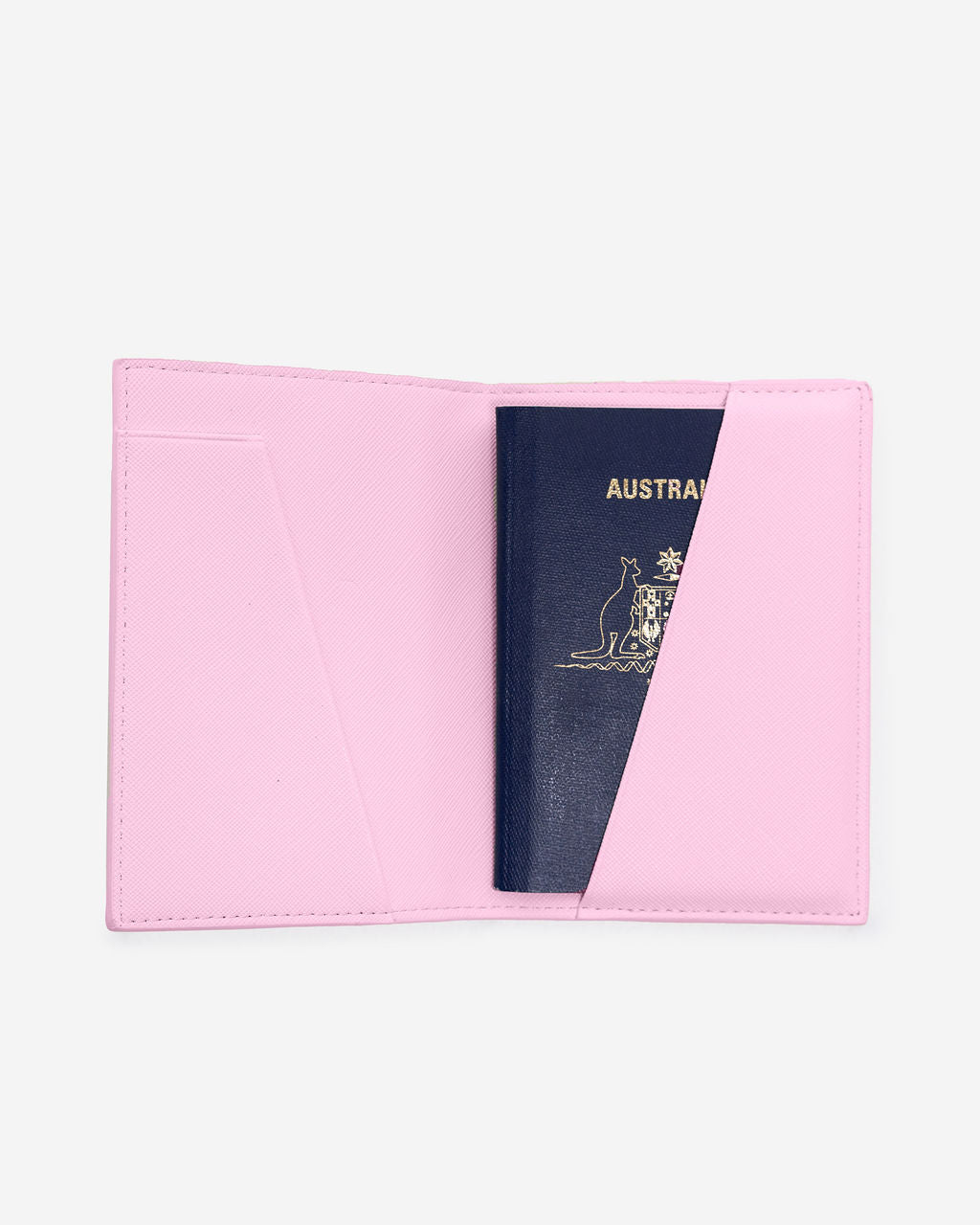 Open light pink Saffiano leather passport holder displays an Australian passport partially inserted into the right-hand pocket.