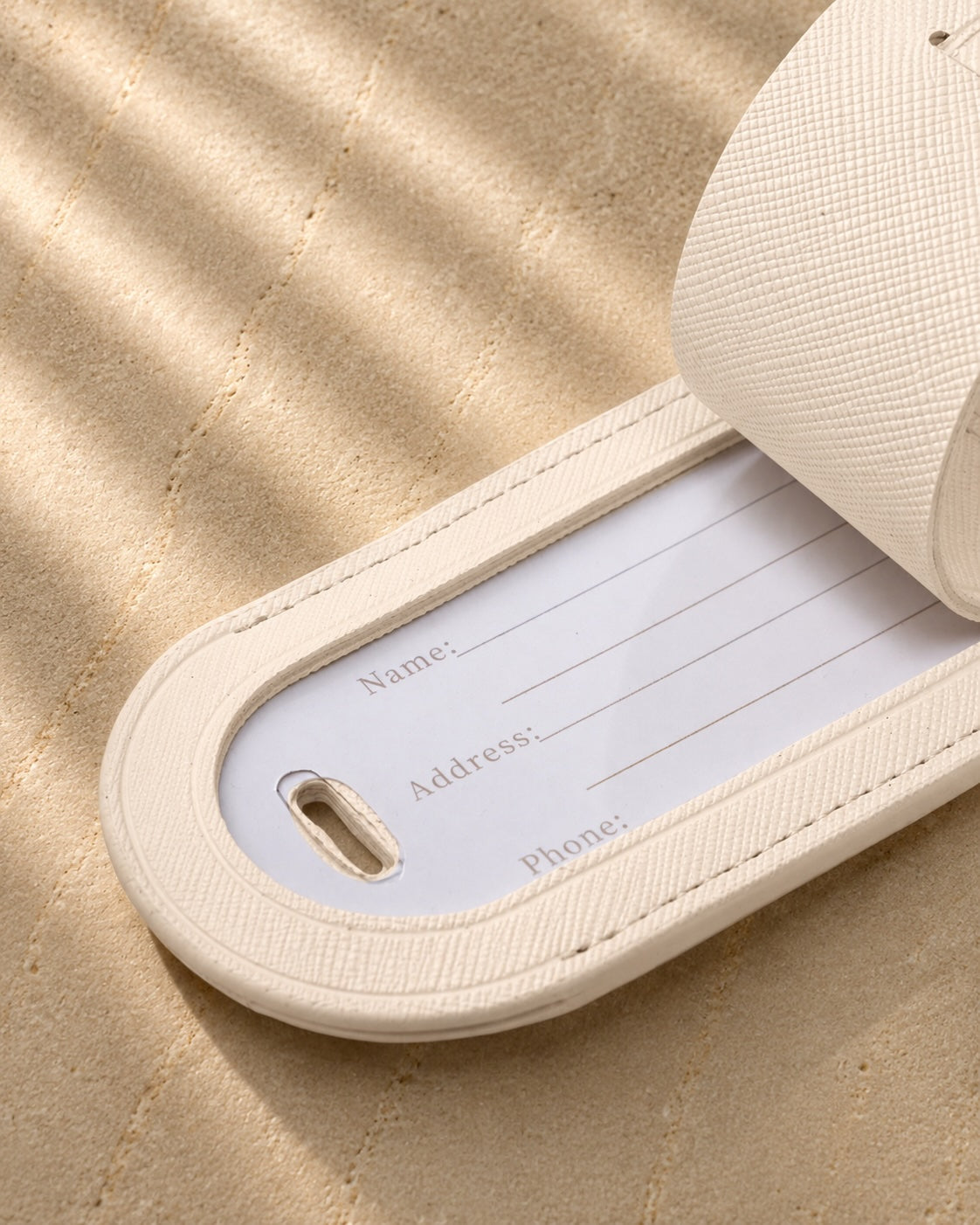 ivory luggage tag open with information card inside