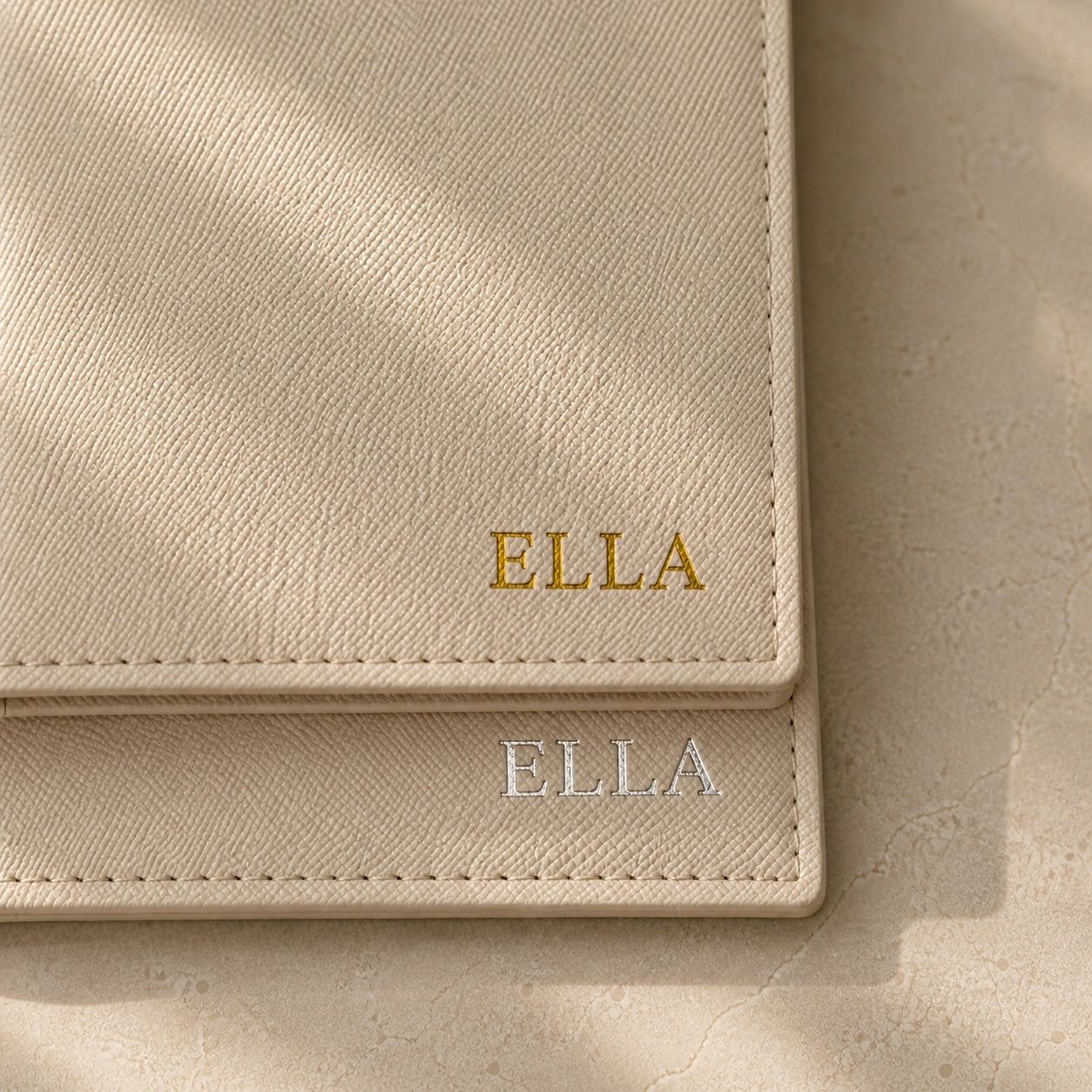 Beige leather wallet with 'ELLA' branding on a matching background